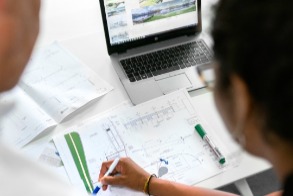 Female civil engineer discusses flood risk management plans with colleague